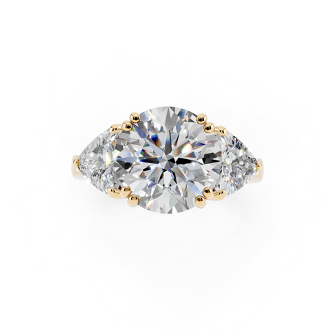 Yellow gold Round Brilliant and Trilliant Diamond Three-Stone Ring