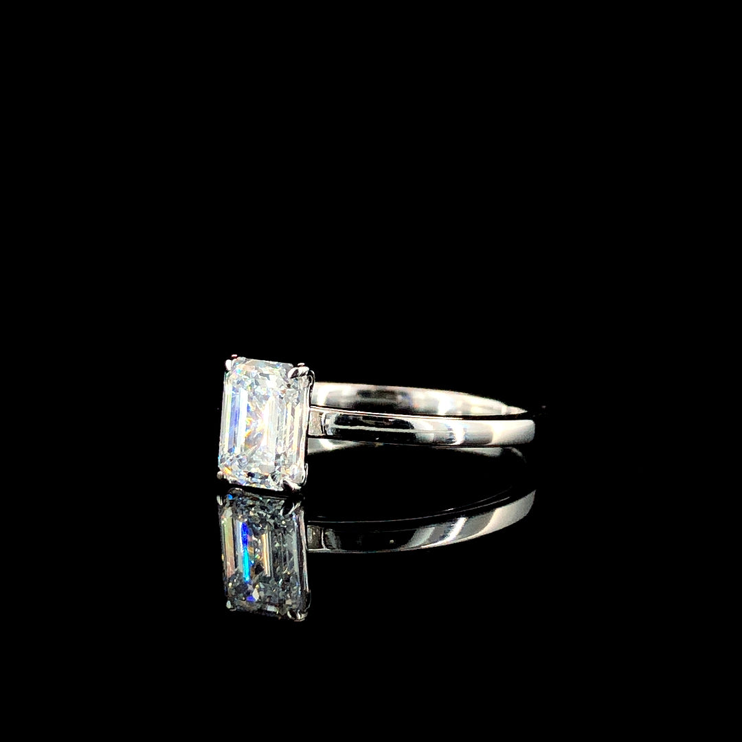 Emerald Solitaire Engagement Ring with Silver Band and Four-Prong Setting