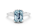 Platinum Emerald Cut Aquamarine Solitaire Ring with Flower Prong Setting and Classic Band