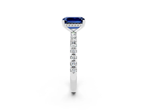 Platinum Emerald Cut Blue Sapphire Solitaire Ring with Round Pavé Band and Four-Prong Setting
