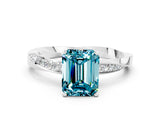 Platinum Emerald Cut Blue Topaz Engagement Ring with Side Stone Accents and Four-Prong Setting_12