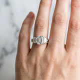 Platinum Emerald Cut Diamond Three-Stone Ring with Channel Set Band and Four-Prong Setting_64