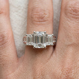 Platinum Emerald Cut Diamond Three-Stone Ring with Channel Set Band and Four-Prong Setting_67