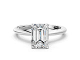 Platinum Emerald Solitaire Diamond Ring with Six-Prong Setting on a Classic Band