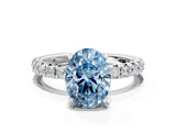 Platinum Fancy Blue Oval Cut Diamond Pavé Solitaire Ring with Round Band and Prong Setting
