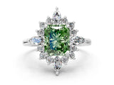 Platinum Fancy Green Radiant Cut Halo Diamond Cluster Ring with Marquise and Round Stones on a White Gold Band with Prong Setting