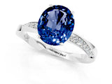 Platinum Oval Cut Blue Sapphire Engagement Ring with Side Stone Accents and Four-Prong Setting_13
