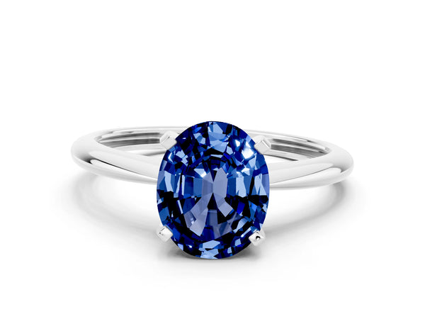 Platinum Oval Cut Blue Sapphire Solitaire Engagement Ring with Classic Band and Four-Prong Setting