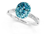 Platinum Oval Cut Blue Topaz Engagement Ring with Side Stone Accents and Four-Prong Setting_13