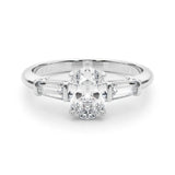 Platinum Oval Cut Diamond Three-Stone Ring with Tapered Baguette Side Stones and Prong Setting 1