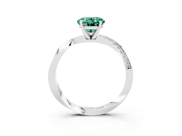 Platinum Oval Cut Green Sapphire Engagement Ring with Side Stone Accents and Four-Prong Setting