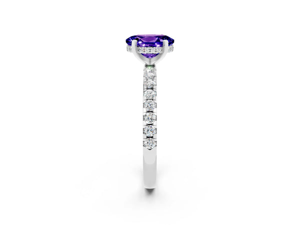 Platinum Oval Cut Tanzanite Solitaire Ring with Round Pavé Band and Four-Prong Setting