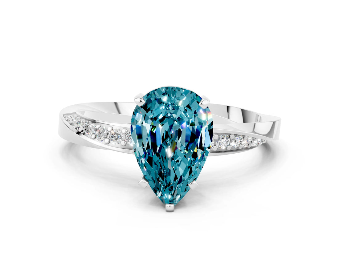 Platinum Pear Cut Blue Topaz Engagement Ring with Side Stone Accents and Four-Prong Setting_12
