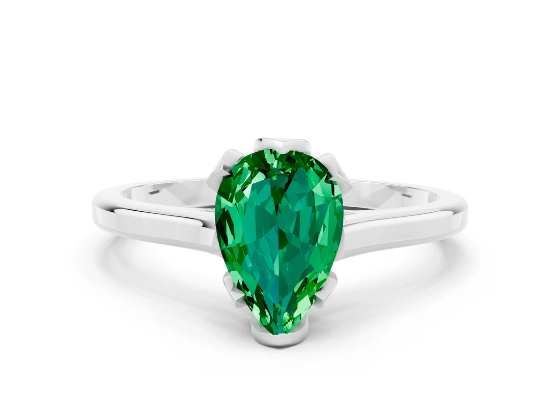 Platinum Pear Cut Emerald Solitaire Ring with Flower Prong Setting and Classic Band