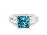 Platinum Princess Cut Blue Topaz Solitaire Engagement Ring with Cathedral Setting and Four-Prong Mount