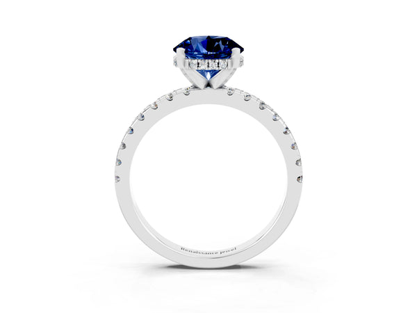 Platinum Round Cut Blue Sapphire Solitaire Ring with Round Pavé Band and Four-Prong Setting