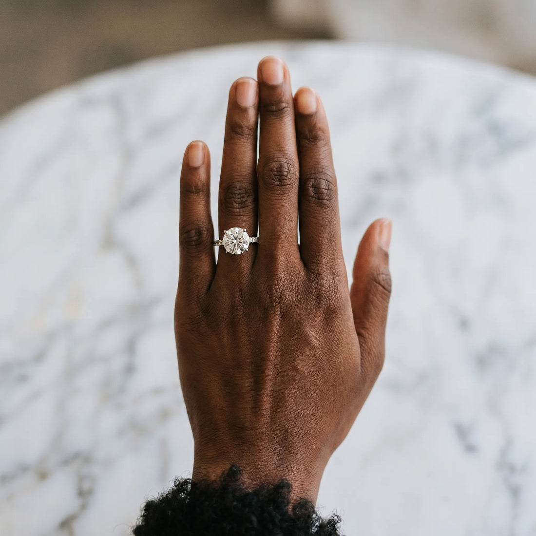 Platinum Round Cut Diamond Brilliant Solitaire Ring with Pavé Band and Four-Prong Setting