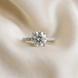 Platinum Round Cut Diamond Brilliant Solitaire Ring with Pavé Band and Four-Prong Setting