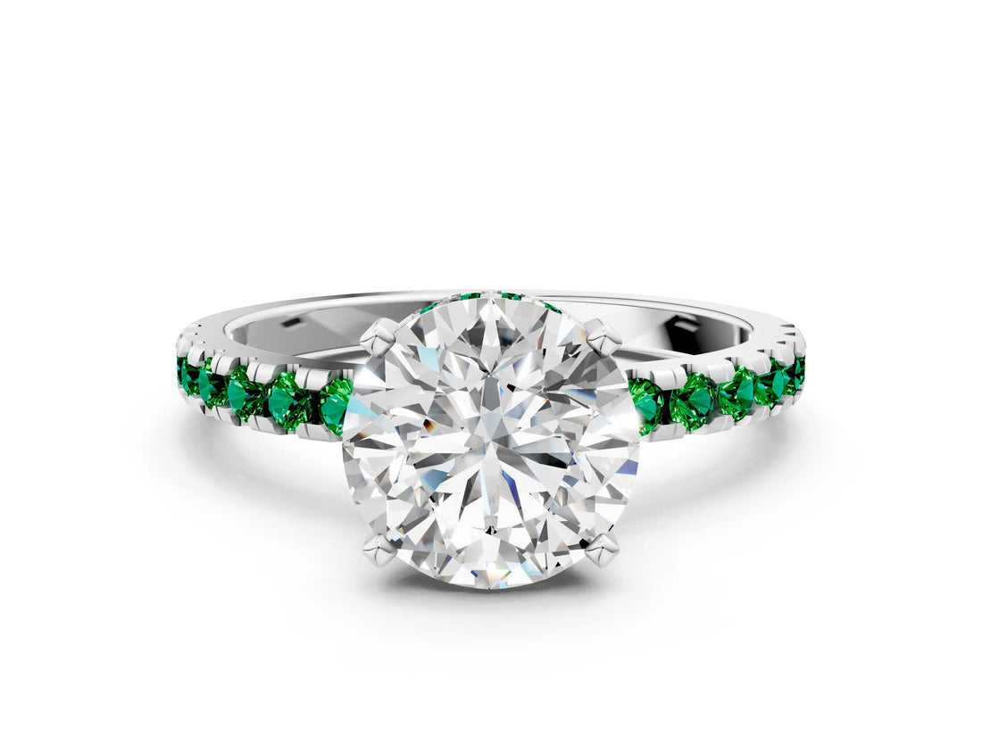 Platinum Round Cut Diamond Solitaire Ring with Round with Emerald side stone Pavé Band and Four-Prong Setting_12
