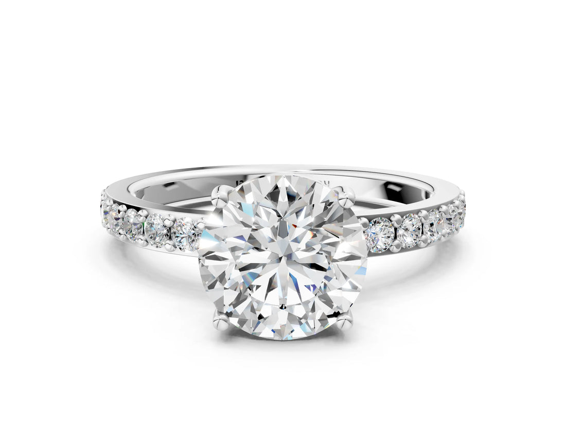 Platinum Round Cut Diamond Solitaire with Pave Band and Four-Prong Setting