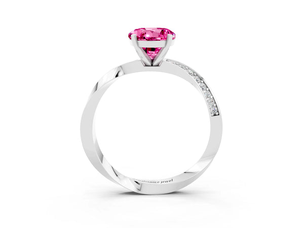 Platinum Round Cut Pink Sapphire Engagement Ring with Side Stone Accents and Four-Prong Setting
