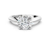 Platinum Round Cut Solitaire Engagement Ring with Tapered Band and Four-Prong Setting