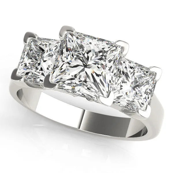 Platinum Three-Stone Cushion Cut Diamond Ring with Channel Set Band and Four-Prong Setting