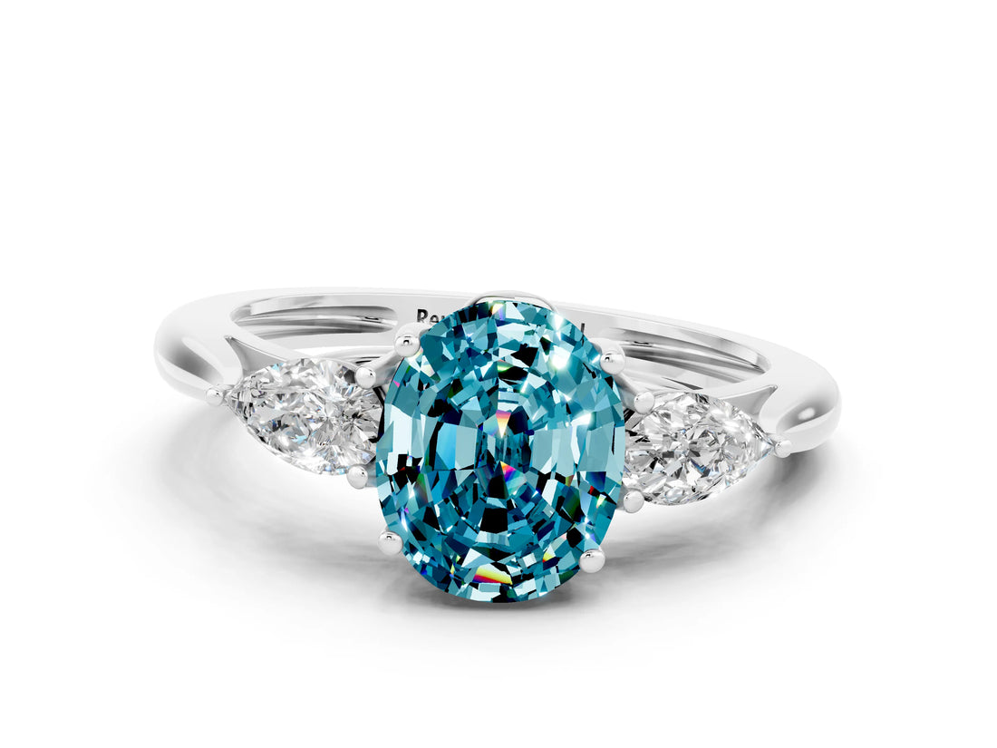 Platinum Three-Stone Oval Cut Blue Topaz Ring with Pear  Side Stones in Four-Prong Setting_54