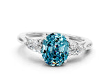 Platinum Three-Stone Oval Cut Blue Topaz Ring with Pear  Side Stones in Four-Prong Setting_54