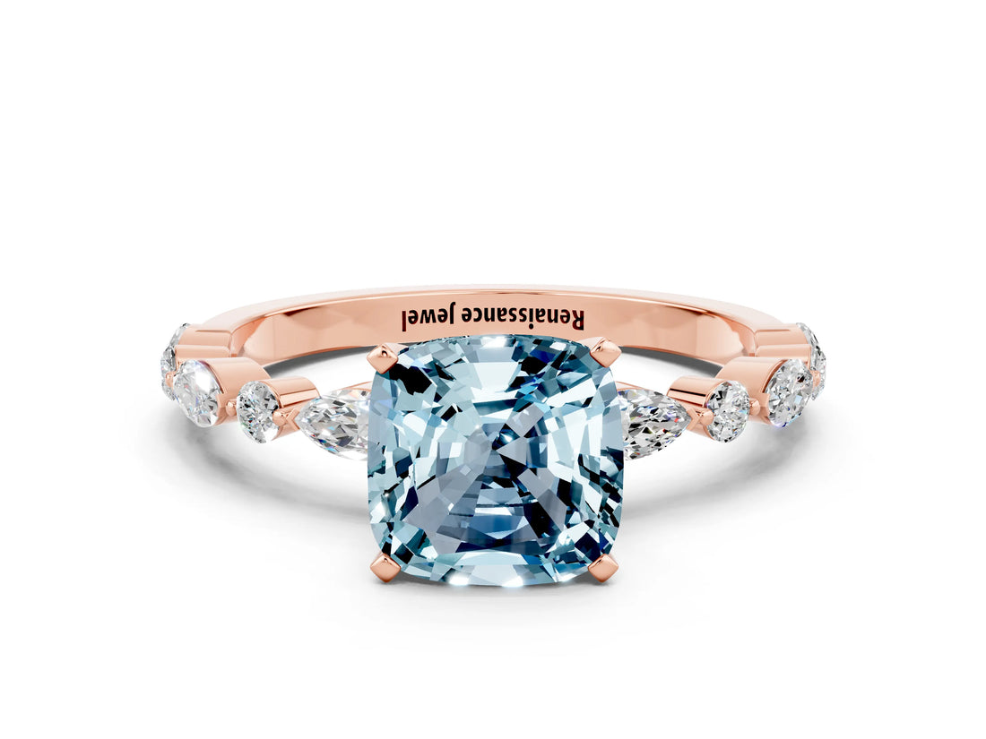 Rose gold Cushion Cut Aquamarine Solitaire with Side Stones on a Pavé Band and Four-Prong Setting