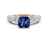 Rose gold Cushion Cut Blue Sapphire Prong Setting with Side Stones on a Pave Band