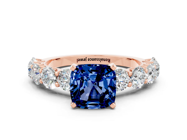 Rose gold Cushion Cut Blue Sapphire Prong Setting with Side Stones on a Pave Band