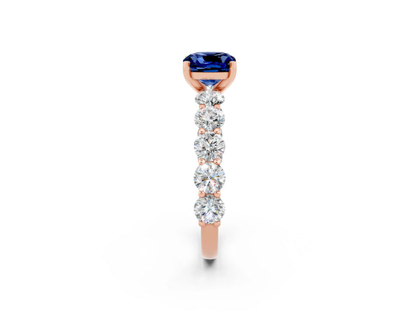 Rose gold Cushion Cut Blue Sapphire Prong Setting with Side Stones on a Pave Band