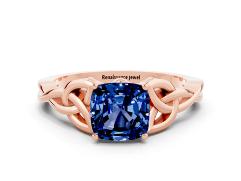 Rose gold Cushion Cut Blue Sapphire Solitaire Engagement Ring with Celtic Knot Band and Four-Prong Setting