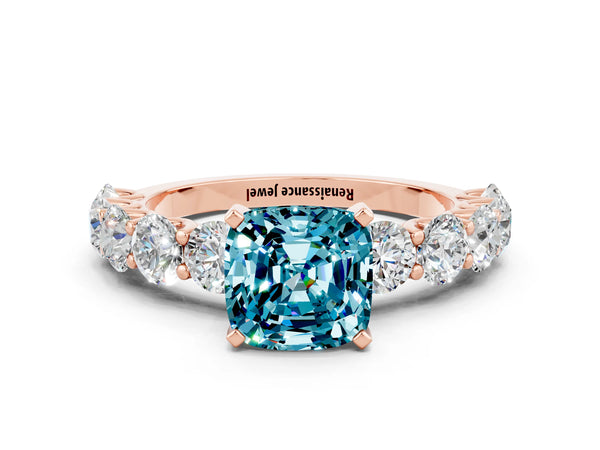 Rose gold Cushion Cut Blue Topaz Prong Setting with Side Stones on a Pave Band