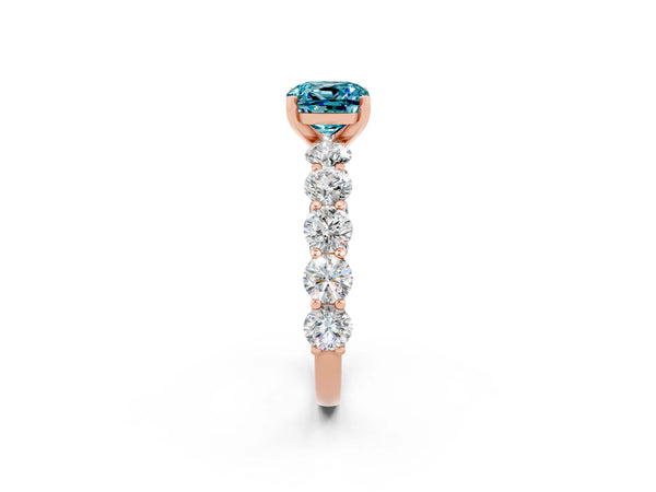 Rose gold Cushion Cut Blue Topaz Prong Setting with Side Stones on a Pave Band