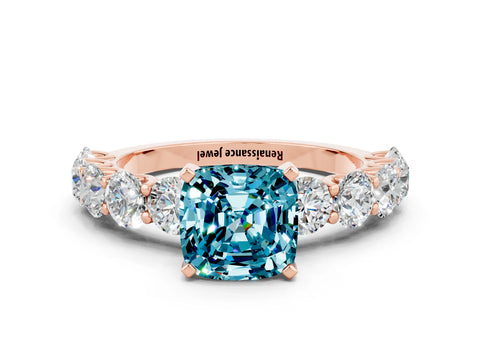 Rose gold Cushion Cut Blue Topaz Prong Setting with Side Stones on a Pave Band