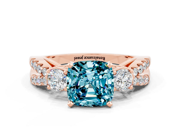 Rose gold Cushion Cut Blue Topaz Three-Stone Ring with Pavé Split Shank and Four-Prong Setting
