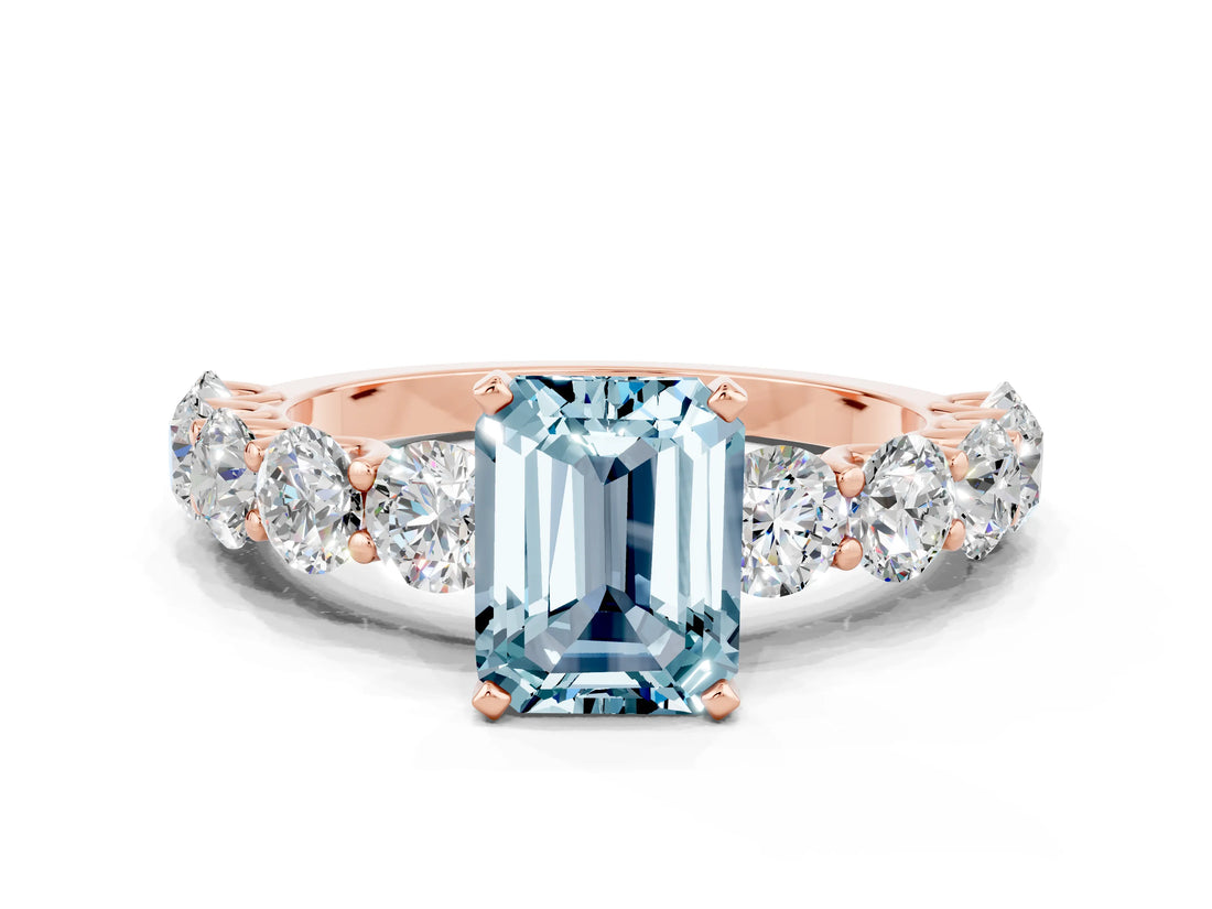 Rose gold Emerald Cut Aquamarine Prong Setting with Side Stones on a Pave Band