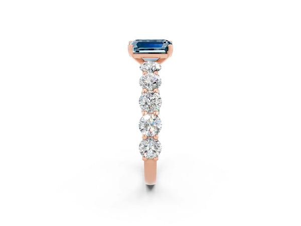 Rose gold Emerald Cut Aquamarine Prong Setting with Side Stones on a Pave Band
