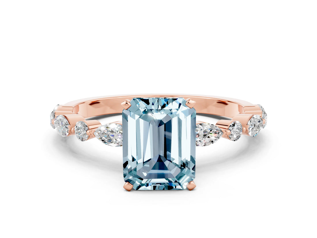 Rose gold Emerald Cut Aquamarine Solitaire with Side Stones on a Pavé Band and Four-Prong Setting