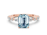 Rose gold Emerald Cut Aquamarine Solitaire with Side Stones on a Pavé Band and Four-Prong Setting