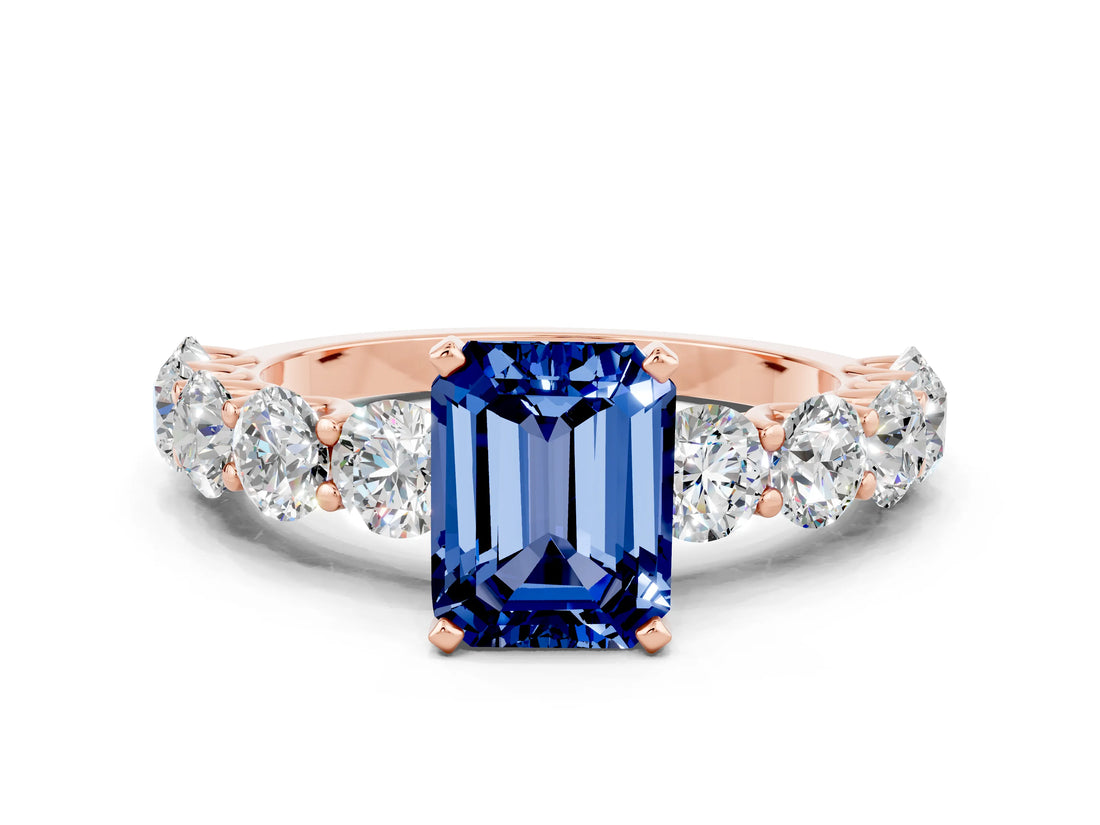 Rose gold Emerald Cut Blue Sapphire Prong Setting with Side Stones on a Pave Band
