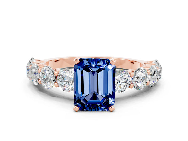 Rose gold Emerald Cut Blue Sapphire Prong Setting with Side Stones on a Pave Band