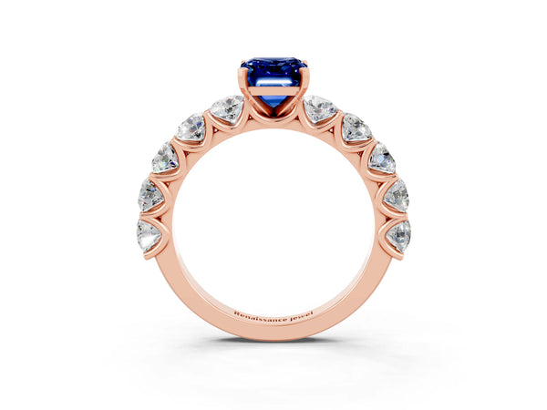 Rose gold Emerald Cut Blue Sapphire Prong Setting with Side Stones on a Pave Band