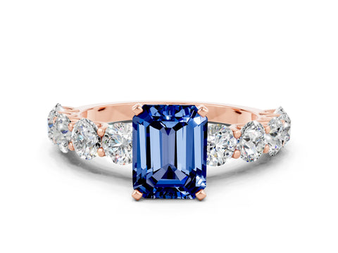 Rose gold Emerald Cut Blue Sapphire Prong Setting with Side Stones on a Pave Band