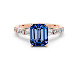 Rose gold Emerald Cut Blue Sapphire Solitaire with Side Baguettes and Channel Set Band