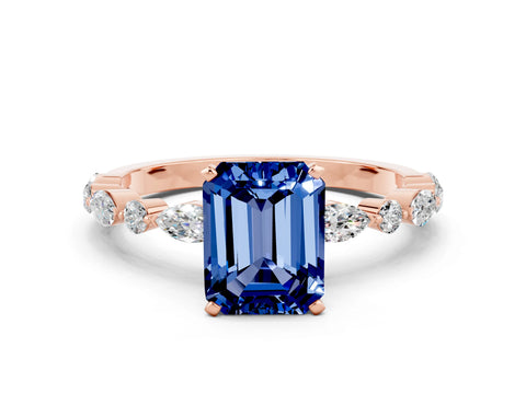 Rose gold Emerald Cut Blue Sapphire Solitaire with Side Stones on a Pavé Band and Four-Prong Setting