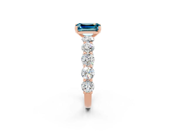 Rose gold Emerald Cut Blue Topaz Prong Setting with Side Stones on a Pave Band