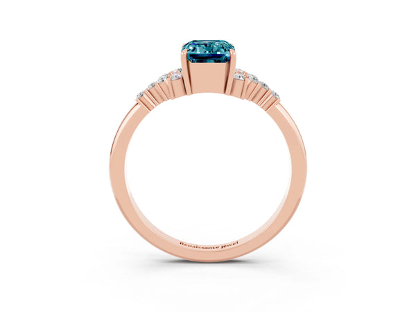 Rose gold Emerald Cut Blue Topaz Ring with Side Stones and Four-Prong Setting